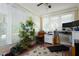 Bright and sunny sunroom filled with plants and a workspace, perfect for relaxation and productivity at 8517 Falkirk Ridge Ct, Wake Forest, NC 27587