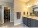 Bright bathroom with dual sink vanity and walk-in closet for ample storage at 90 Heathgreen Dr, Clayton, NC 27527
