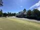Beautiful clubhouse with a covered patio, a clock, and a manicured lawn at 90 Heathgreen Dr, Clayton, NC 27527