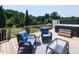 Outdoor deck area featuring wicker furniture, a hot tub, and scenic views at 90 Heathgreen Dr, Clayton, NC 27527