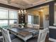 Dining room with rustic table, stylish chandelier, and views into the kitchen and entry hallway at 90 Heathgreen Dr, Clayton, NC 27527