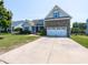 Charming two-story home featuring a stone accented facade, well-manicured lawn, and a double car garage at 90 Heathgreen Dr, Clayton, NC 27527