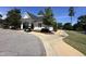 Charming exterior of clubhouse with golf cart parking and sidewalk path at 90 Heathgreen Dr, Clayton, NC 27527