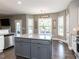 Open concept kitchen with granite countertops, stainless appliances, and island with a gray base at 90 Heathgreen Dr, Clayton, NC 27527