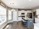 Kitchen and breakfast area with white cabinets, granite countertops, stainless appliances, and island with seating at 90 Heathgreen Dr, Clayton, NC 27527