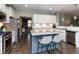 Kitchen with white cabinets, granite countertops, stainless appliances, and an island with seating at 90 Heathgreen Dr, Clayton, NC 27527