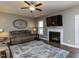 Comfortable living room boasts a fireplace, ceiling fan, and stylish area rug at 90 Heathgreen Dr, Clayton, NC 27527