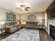 Comfortable living room featuring hardwood floors, ceiling fan, fireplace, and neutral decor at 90 Heathgreen Dr, Clayton, NC 27527