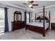 Spacious main bedroom featuring a tray ceiling, a ceiling fan and elegant wood furniture at 90 Heathgreen Dr, Clayton, NC 27527