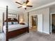 Well-lit main bedroom with tray ceiling and ensuite bathroom featuring a glass shower at 90 Heathgreen Dr, Clayton, NC 27527