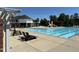Community pool featuring lounge chairs, a kiddie slide, and ample seating at 90 Heathgreen Dr, Clayton, NC 27527