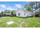 Spacious backyard featuring a lush green lawn, horseshoe pit, and privacy fencing at 901 N Taylor St, Wake Forest, NC 27587