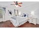 Comfortable bedroom with a ceiling fan, hardwood floors, and white furniture at 901 N Taylor St, Wake Forest, NC 27587