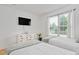 Bright bedroom with twin beds, dresser with TV, and a large window with scenic views at 901 N Taylor St, Wake Forest, NC 27587