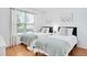 Bright bedroom with twin beds, wood floors and a large window with scenic views at 901 N Taylor St, Wake Forest, NC 27587