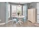 Bright dining area with a round table set, a bay window, and light blue chairs at 901 N Taylor St, Wake Forest, NC 27587