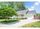 Well-maintained home featuring a two-car garage, a covered porch and a manicured front lawn at 901 N Taylor St, Wake Forest, NC 27587