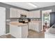 Efficient kitchen with white cabinetry, gray countertops and a view into the dining area at 901 N Taylor St, Wake Forest, NC 27587