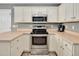 Well-equipped kitchen featuring white cabinets, stainless steel appliances, and neutral countertops at 901 N Taylor St, Wake Forest, NC 27587