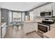 Open concept kitchen with stainless steel appliances and an adjacent dining area with bay windows at 901 N Taylor St, Wake Forest, NC 27587