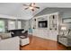 Open living room with a built-in entertainment center, vaulted ceiling, and hardwood floors at 901 N Taylor St, Wake Forest, NC 27587