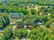 A detailed aerial shot focuses on the property nestled among mature trees and other residences at 9220 Old Cascade Dr, Garner, NC 27529