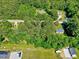 An aerial view of wooded land and homes with mature trees, showcasing the serene neighborhood at 9220 Old Cascade Dr, Garner, NC 27529