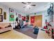 Finished basement space features an exercise area with weight equipment, dart board, and sports decor at 9220 Old Cascade Dr, Garner, NC 27529