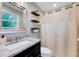 Bathroom featuring vanity with granite top, shower with curtain, and wood shelves at 9220 Old Cascade Dr, Garner, NC 27529