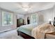 Spacious bedroom with ceiling fan, two windows, a chest of drawers and calming decor at 9220 Old Cascade Dr, Garner, NC 27529