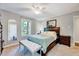 Comfortable bedroom featuring carpet, ceiling fan, large windows, bench and neutral decor at 9220 Old Cascade Dr, Garner, NC 27529