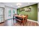 Dining room with hardwood floors, modern lighting, and a stylish accent wall at 9220 Old Cascade Dr, Garner, NC 27529