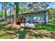 A charming single-story home features a wooden deck and is nestled among trees at 9220 Old Cascade Dr, Garner, NC 27529