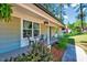 Charming covered front porch with seating and an American flag, perfect for enjoying the outdoors at 9220 Old Cascade Dr, Garner, NC 27529