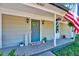 Welcoming front porch with a blue door, decorative plants, and a 'Welcome Home' mat at 9220 Old Cascade Dr, Garner, NC 27529
