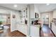Well-lit kitchen with white cabinetry, stainless steel appliances, and hardwood floors at 9220 Old Cascade Dr, Garner, NC 27529