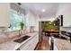 Bright kitchen with white cabinets, granite countertops, stainless steel appliances, and a view of the backyard at 9220 Old Cascade Dr, Garner, NC 27529