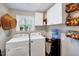 Well-lit laundry room with washer, dryer, and practical storage solutions at 9220 Old Cascade Dr, Garner, NC 27529