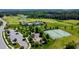 Aerial view of community amenities, including a playground, tennis court, and golf course at 94 Two Creeks, Chapel Hill, NC 27517