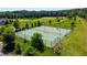 Aerial view showcases the community tennis courts amidst lush landscaping, offering a scenic and active lifestyle at 94 Two Creeks, Chapel Hill, NC 27517