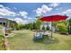 Lush backyard with a dining set, mature trees, and manicured landscaping at 94 Two Creeks, Chapel Hill, NC 27517
