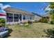 Landscaped backyard featuring a screened porch, a grilling area, and a lush lawn at 94 Two Creeks, Chapel Hill, NC 27517