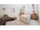 Bedroom with a metal bed frame, vanity table, sitting chair, and neutral colored walls and carpet at 94 Two Creeks, Chapel Hill, NC 27517