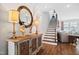 Foyer with hardwood floors and staircase, ornate mirror and decorative furniture pieces in neutral colors at 94 Two Creeks, Chapel Hill, NC 27517