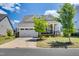 Charming home featuring a two-car garage and inviting front porch with stone accents at 94 Two Creeks, Chapel Hill, NC 27517