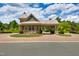 Charming gatehouse entrance with stone and shingle accents, providing security and curb appeal to the community at 94 Two Creeks, Chapel Hill, NC 27517