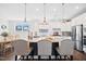 Modern kitchen featuring a large island with bar seating, stainless steel appliances, and stylish pendant lighting at 94 Two Creeks, Chapel Hill, NC 27517