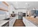 Spacious kitchen with granite countertops, stainless steel appliances, and stylish white cabinetry for modern living at 94 Two Creeks, Chapel Hill, NC 27517