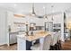 Well-lit kitchen with stainless steel appliances, granite countertops, and a spacious island with barstool seating at 94 Two Creeks, Chapel Hill, NC 27517