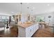 Spacious kitchen boasts granite counters, an island with pendant lights, and a seamless flow to the dining area at 94 Two Creeks, Chapel Hill, NC 27517